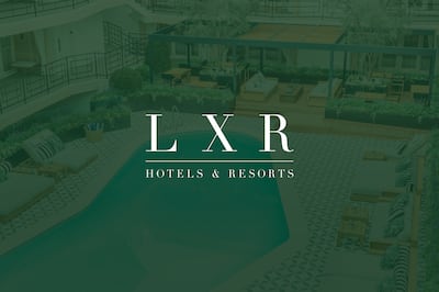 Outdoor Pool with Seating Area and Veranda with the LXR Hotels & Resorts logo layered over the top of the image and as part of the image